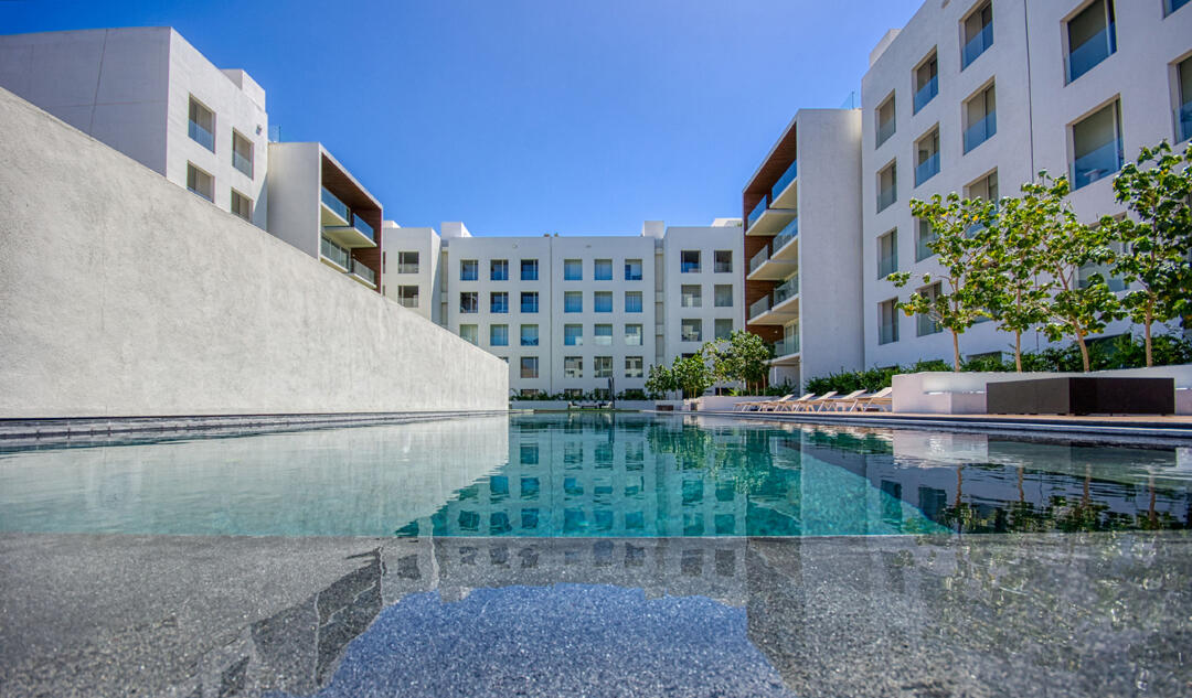 Los Cabos Brisas Del Tezal Ready for delivery! Brisas del Tezal Penthouse featuring 2 bedrooms and 2 1/2 bathrooms in an exclusive low-density community of 36 units across two 4-story elevator buildings. Located minutes from Medano Beach and downtown Cabo. Showcases excellent construction quality and craftsmanship from the developer, including parota wood carpentry and a large, solid front door. Features large-format tile flooring throughout, spacious balcony, granite countertops and backsplash in the kitchen, bathrooms with marble showers to the ceiling, wall-to-wall closets, and a laundry room with space for side-by-side washer and dryer and storage. Equipped with 1-ton A/C mini-splits in each bedroom and two in the living area.Private rooftop terrace with interior access, pergola, jacuzzi for 6 sink with storage, half bath, and lighting. Enjoy panoramic ocean, El Arco, mountain, sunset, and city for sale